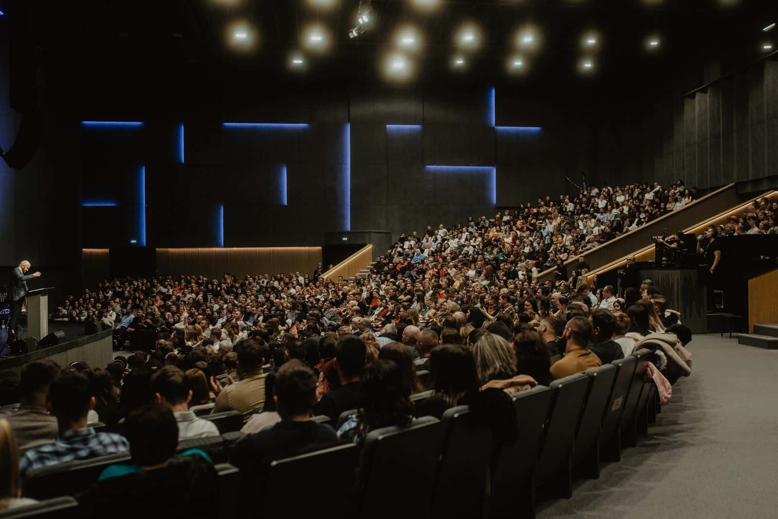 Audience filling a modern conference auditorium