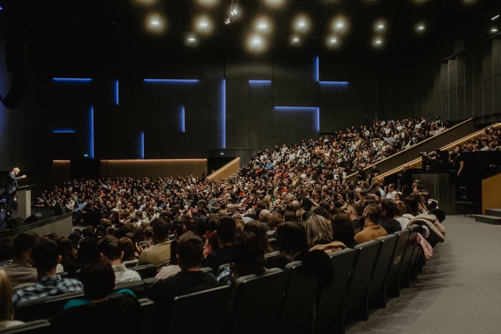 Audience filling a modern conference auditorium